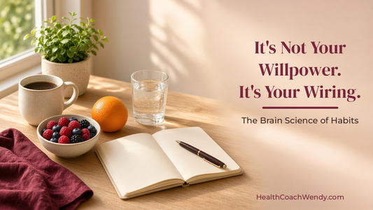 Sunlit morning table with a coffee mug, open journal and pen, small green plant, fresh berries, an orange, and a glass of water, with the title It's Not Your Willpower. It's Your Wiring.